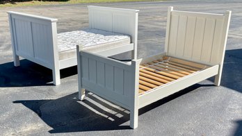 A twin size white painted bed, along