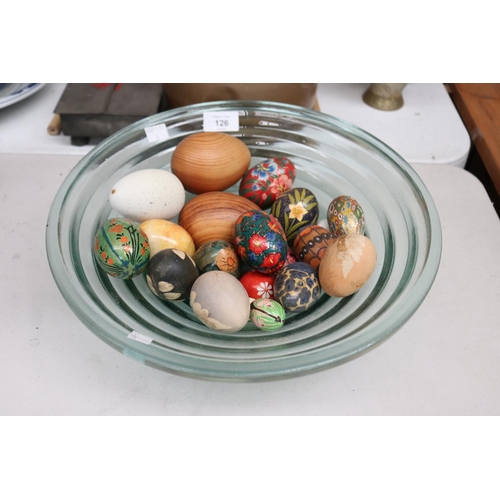 Assortment of decorative eggs in a glass