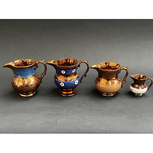 Four antique copper lustre jugs