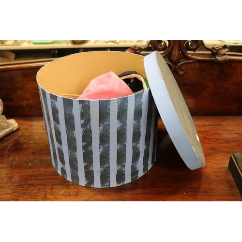 Blue striped hat box with hats,