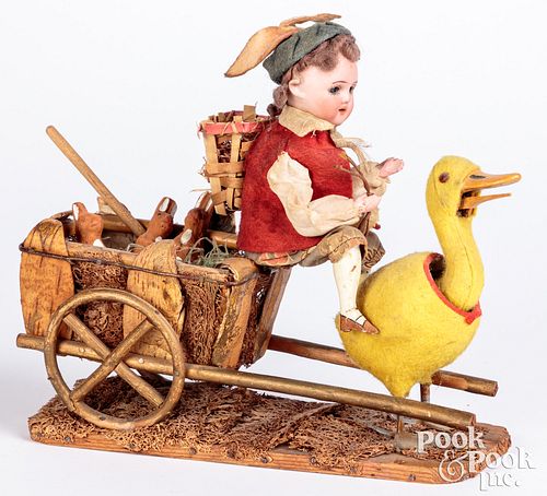 BISQUE HEAD DOLL RIDING A DUCK