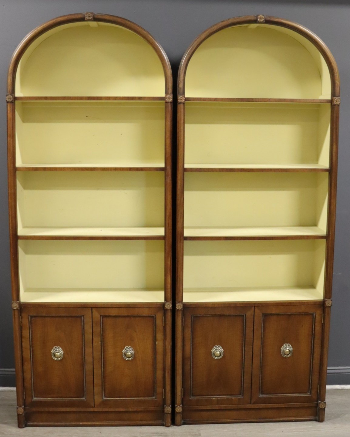 A MIDCENTURY PAIR OF ARCH TOP BOOKCASES.