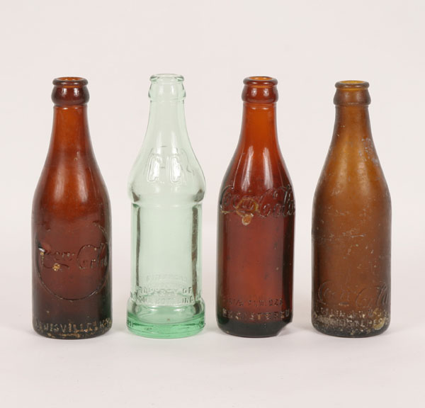 Three molded amber Coke bottles: