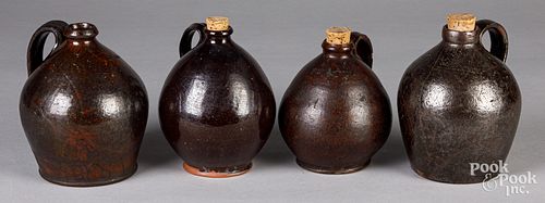 FOUR REDWARE JUGS, 19TH C.Four redware