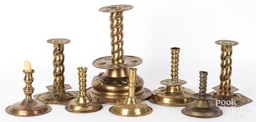 EIGHT EMBOSSED AND ENGRAVED BRASS CANDLESTICKSEight