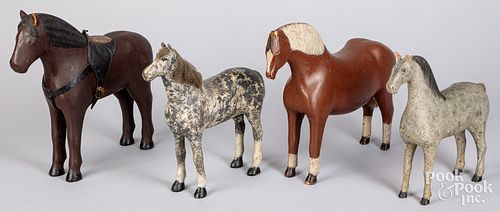 FOUR CARVED AND PAINTED HORSES,