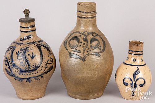 THREE GERMAN STONEWARE PITCHERSThree 30d609