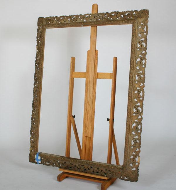 Large ornate gessoed frame; profuse