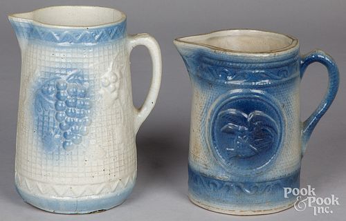 TWO BLUE AND WHITE STONEWARE PITCHERS,