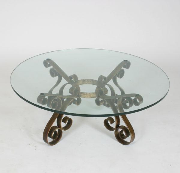 Iron glass top table with scrolling