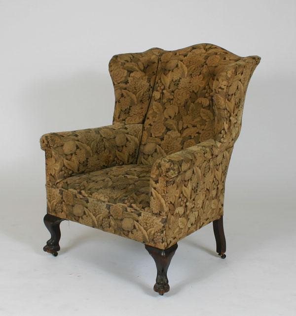 Upholstered wing chair; claw feet and