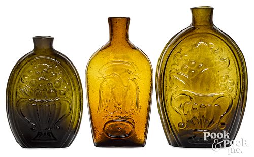 THREE OLIVE AND AMBER GLASS FLASKS