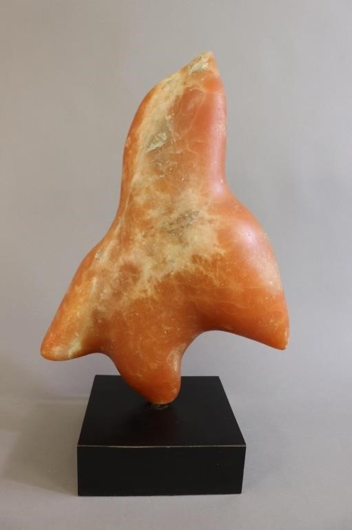 Inuit style carved orange stone sculpture