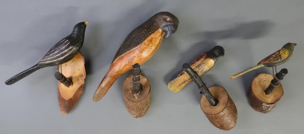 Four carved and painted birds,