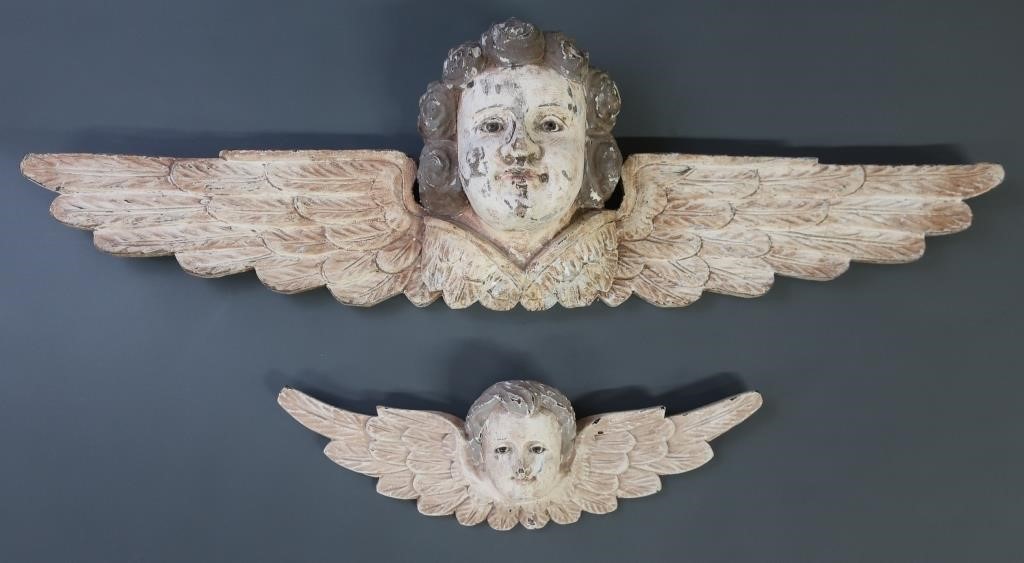 Two carved Victorian style winged angels