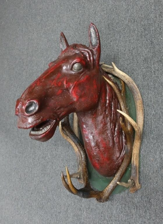 Metal red painted horse head surrounded