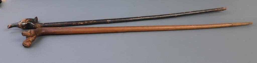 Two walking sticks, one with two carved