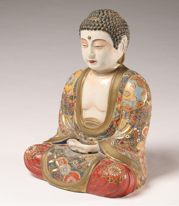Seated porcelain Buddha with gilt and
