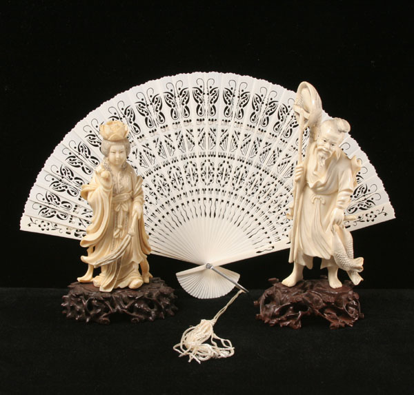 Carved elephant ivory figures with fan;