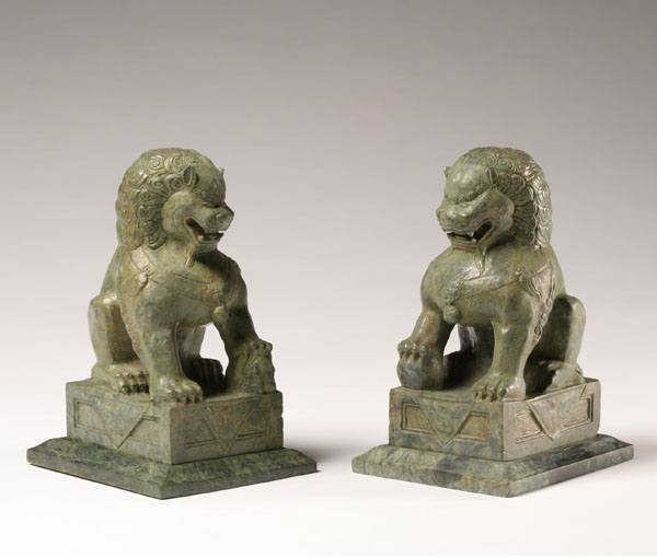 Pair of carved green soapstone foo dogs;