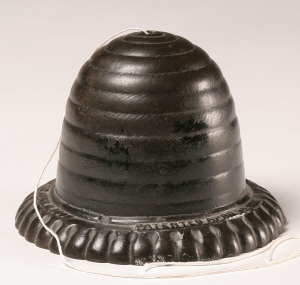 Cast metal string holder; beehive