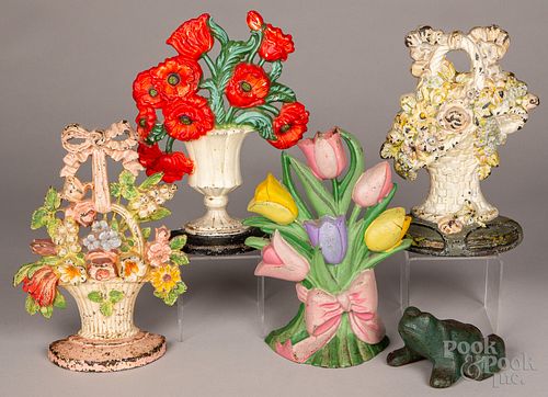 FOUR CAST IRON FLOWER DOORSTOPS,