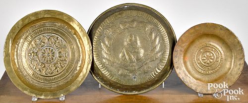 THREE EMBOSSED BRASS ALMS DISHES