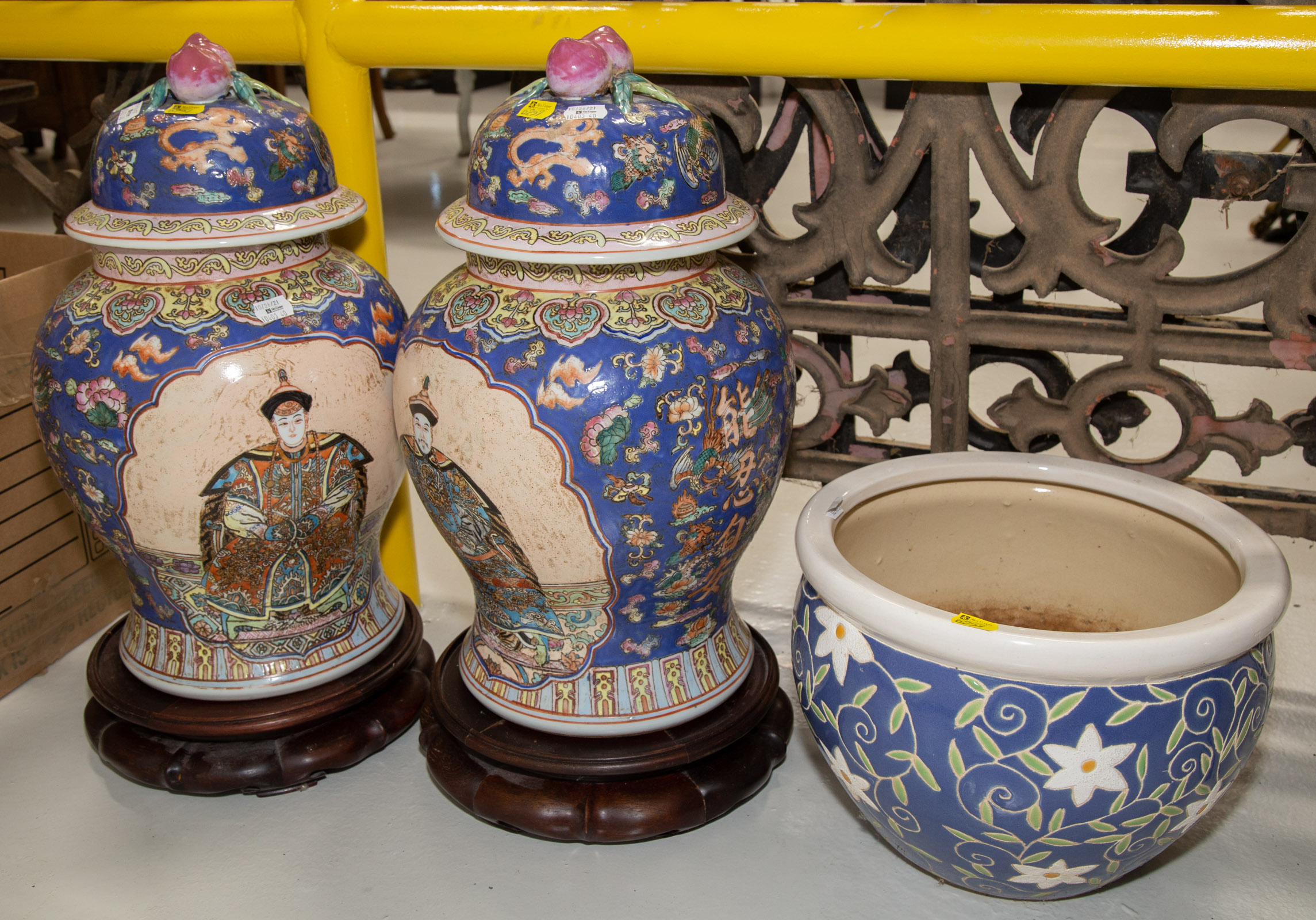 TWO ASIAN STYLE LIDDED JARS ON WOODEN