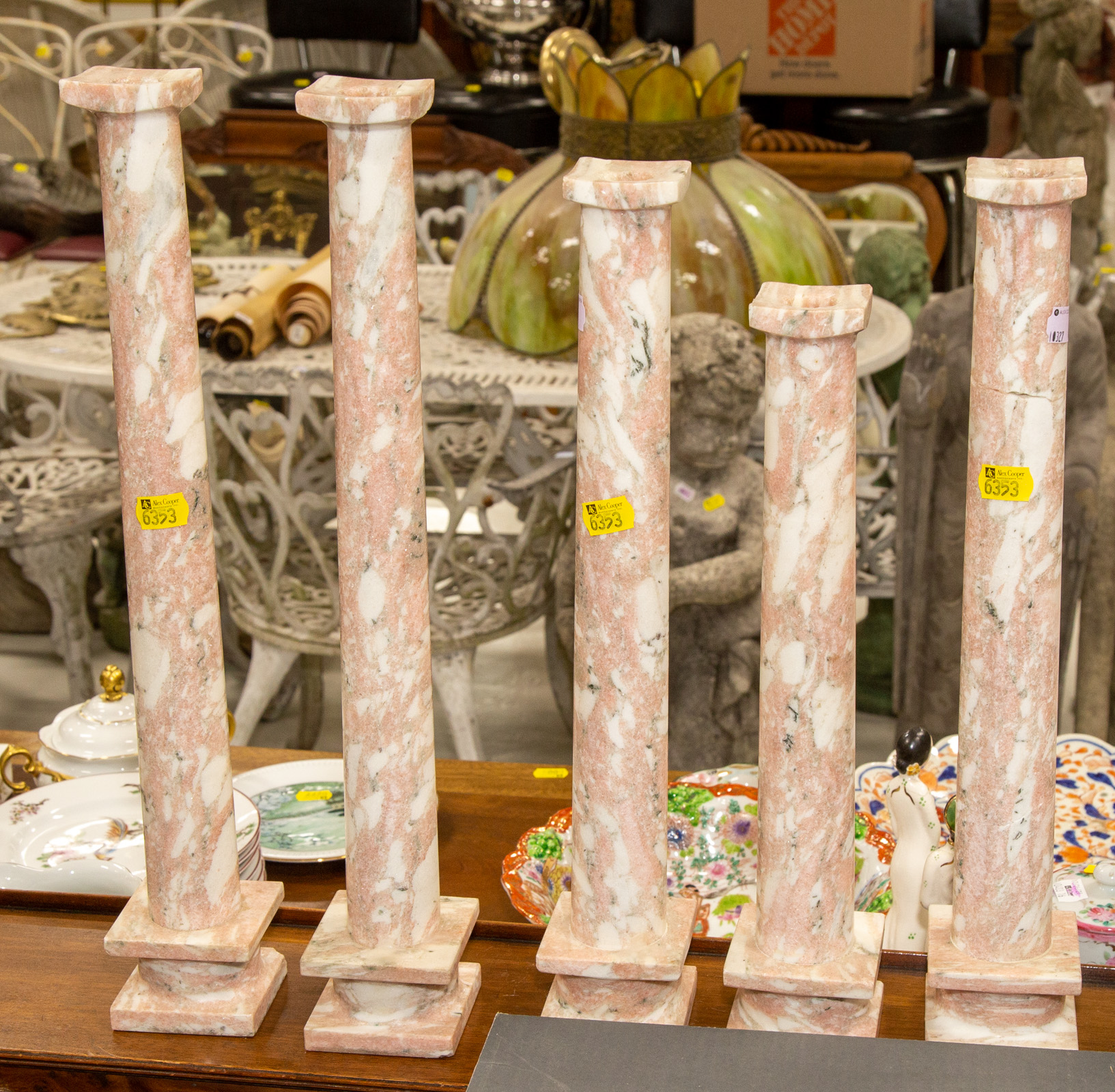 FIVE CARVED PINK MARBLE CANDLESTICKS