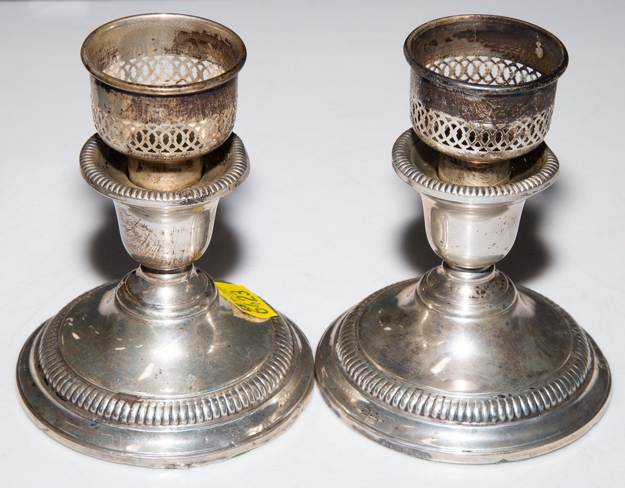 A PAIR OF STERLING WEIGHTED CANDLESTICKS