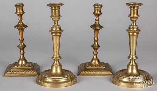 TWO PAIRS OF BRASS CANDLESTICKS