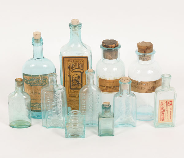 Eleven antique blue glass medicine bottles;