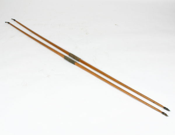 A pair of wooden hunting bows with carved