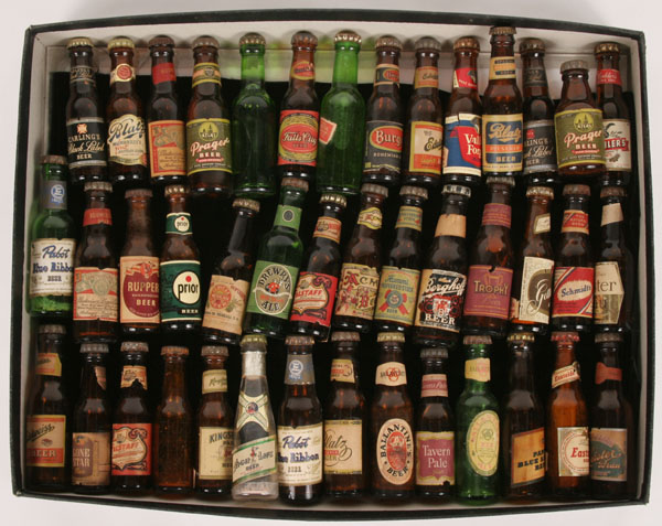 Approximately forty beer bottles, most