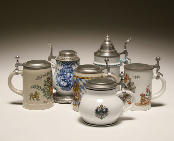 Six German decorated steins; pewter