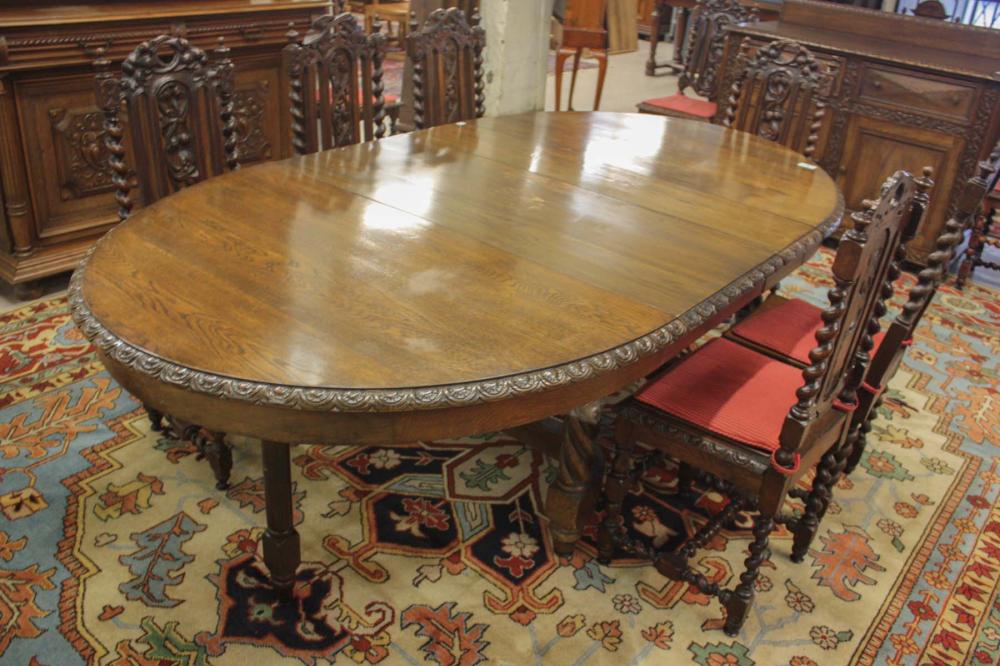 AN OVAL OAK EXTENSION DINING TABLE