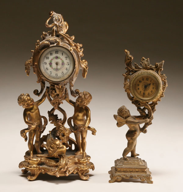 Two gilt metal cherub clocks; ornate