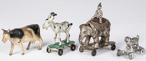 FOUR CAST IRON ANIMALS ON WHEELS 3140a8