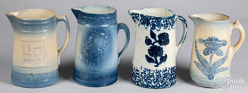 FOUR BLUE AND WHITE STONEWARE PITCHERS,