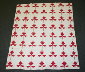 Hand stitched red and white quilt with