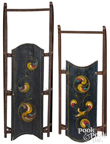 TWO SIMILAR PAINTED SLEDS, WITH