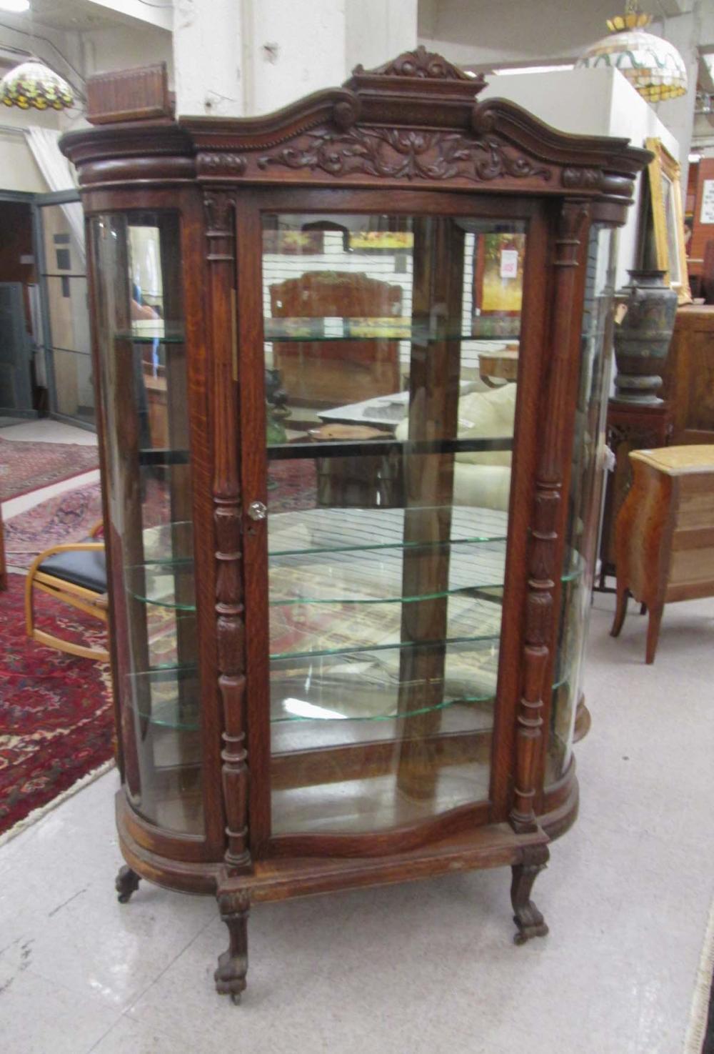 CARVED OAK AND CURVED GLASS CHINA