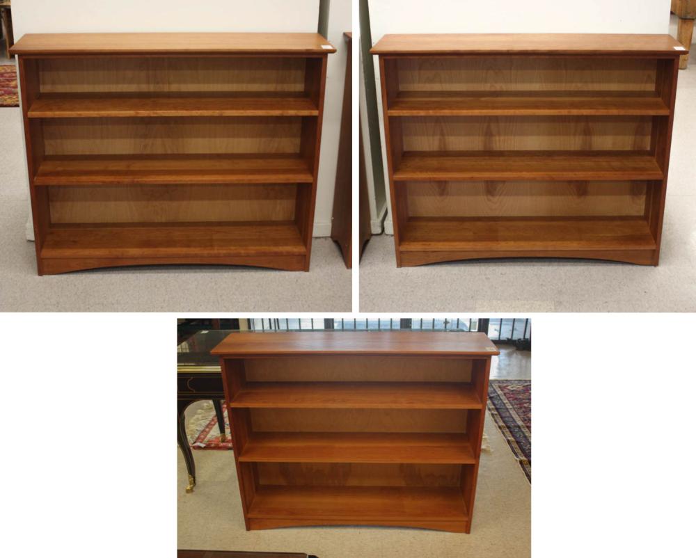A SET OF THREE CHERRY BOOKCASES,