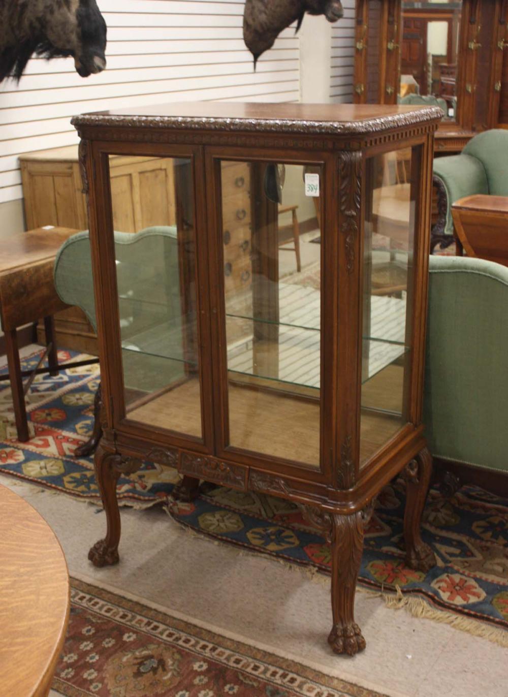 GLASS AND CARVED WALNUT CURIO CABINET,