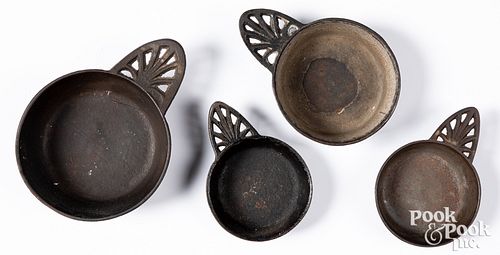 FOUR CAST IRON PORRINGERS, 19TH