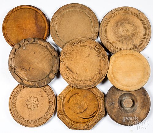 EIGHT CARVED WOOD BREAD PLATES,