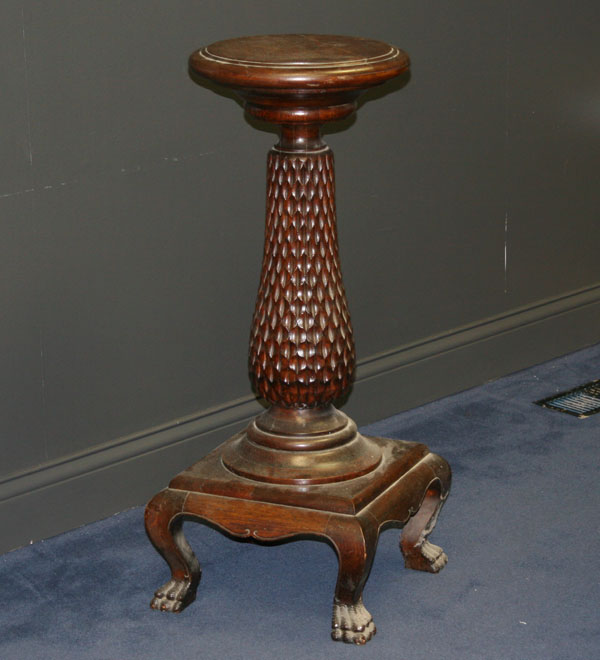 Carved oak pedestal with claw feet;