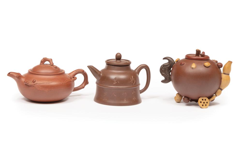 THREE CHINESE YIXING POTTERY TEAPOTSThree 318bf7