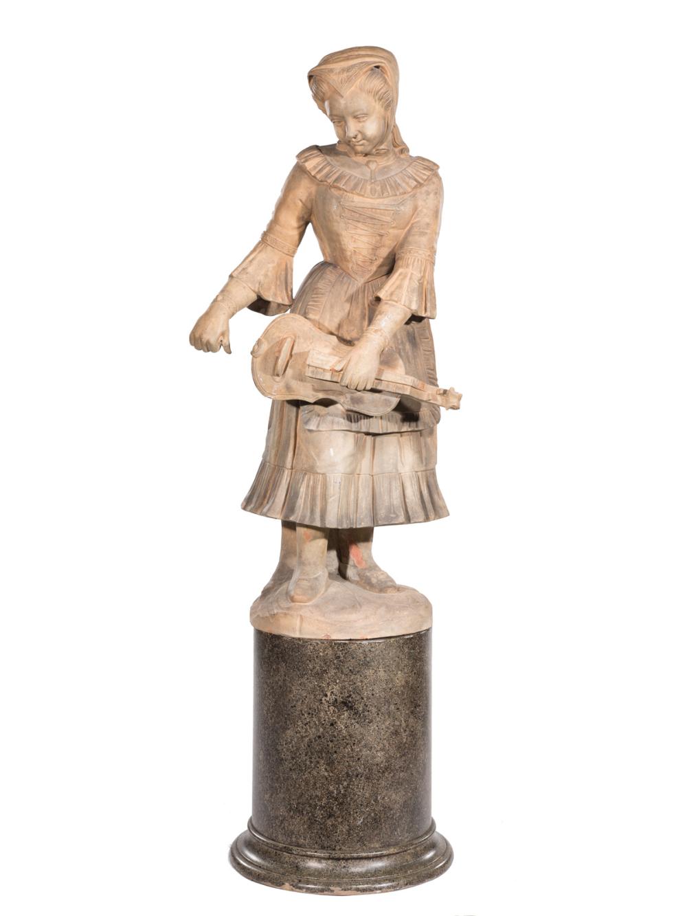 TERRACOTTA FIGURE OF A LADY PLAYING