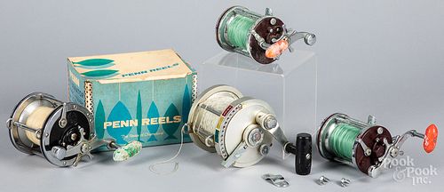 THREE PENN FISHING REELS, AND ANOTHERThree